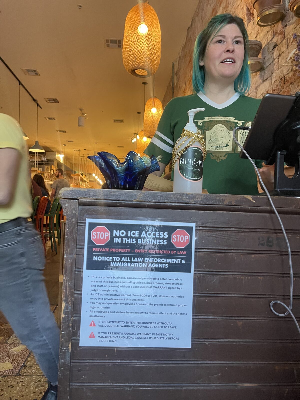 Downtown New Orleans — a 'No ICE' sign in one window and 'For Sale' signs in many others as commerce has been decimated.